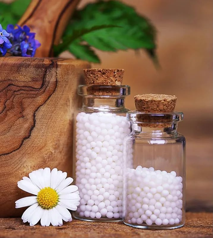 Hands holding a homeopathic remedy with lavender